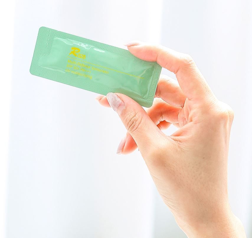 A single 1.3g R828 sunscreen stick held in one hand